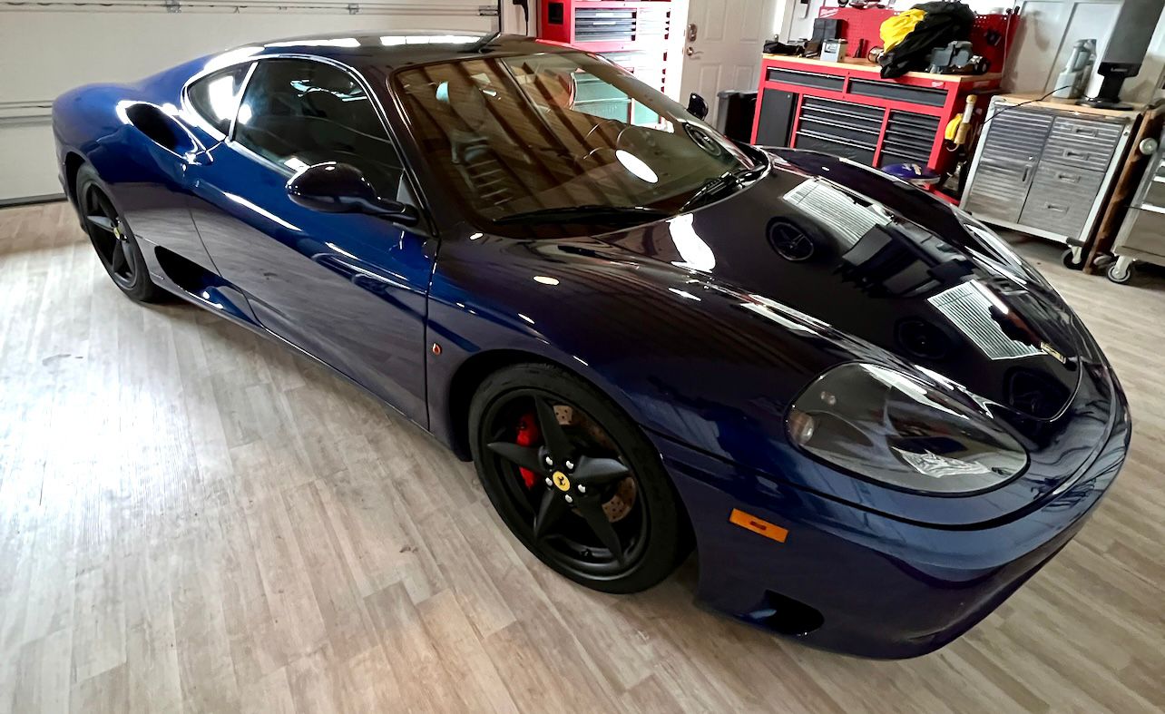 Ferrari after professional detailing and polishing, showcasing a flawless, high-gloss finish with deep paint correction, swirl removal, and a pristine shine that enhances its luxury appearance and protection