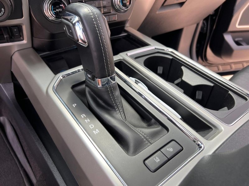 Ford F-150 center console after professional detailing, featuring deep cleaning of all surfaces, leather conditioning, and a polished, like-new finish for a clean and refreshed interior look