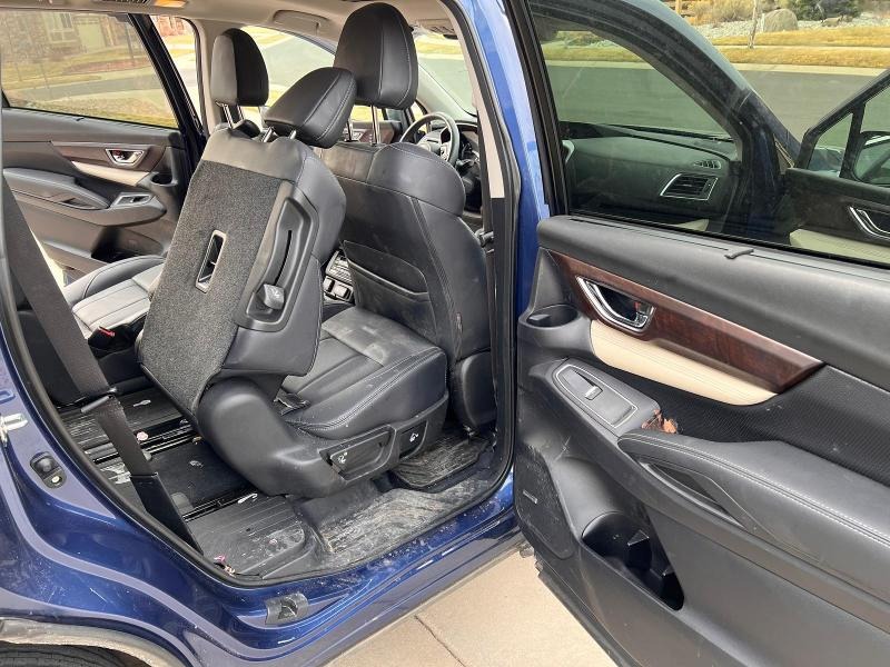 Before detailing: Leather interior showing heavy dirt, stains, and discoloration, with visible buildup on the seats, armrests, and upholstery, in need of professional cleaning and conditioning to restore its original look and feel