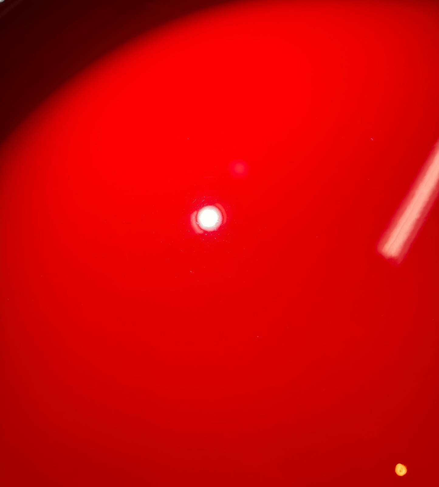 After paint restoration: Vehicle surface with a flawless, smooth finish after professional paint correction, with swirl marks and imperfections removed, revealing a deep, glossy shine and vibrant color