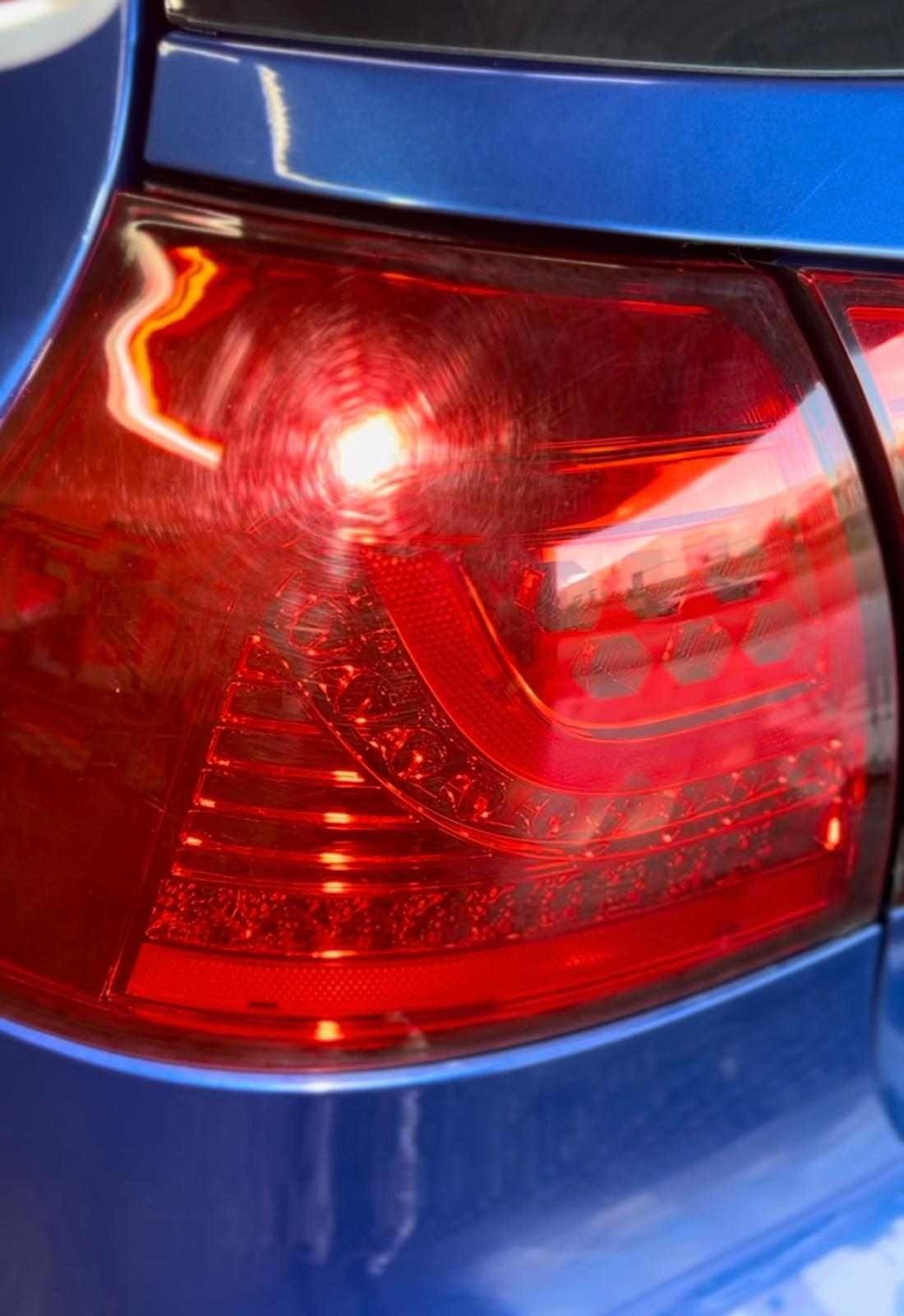 Before restoration: Tail light showing visible scratches, scuffs, and haziness, in need of professional restoration and polishing to restore clarity and shine